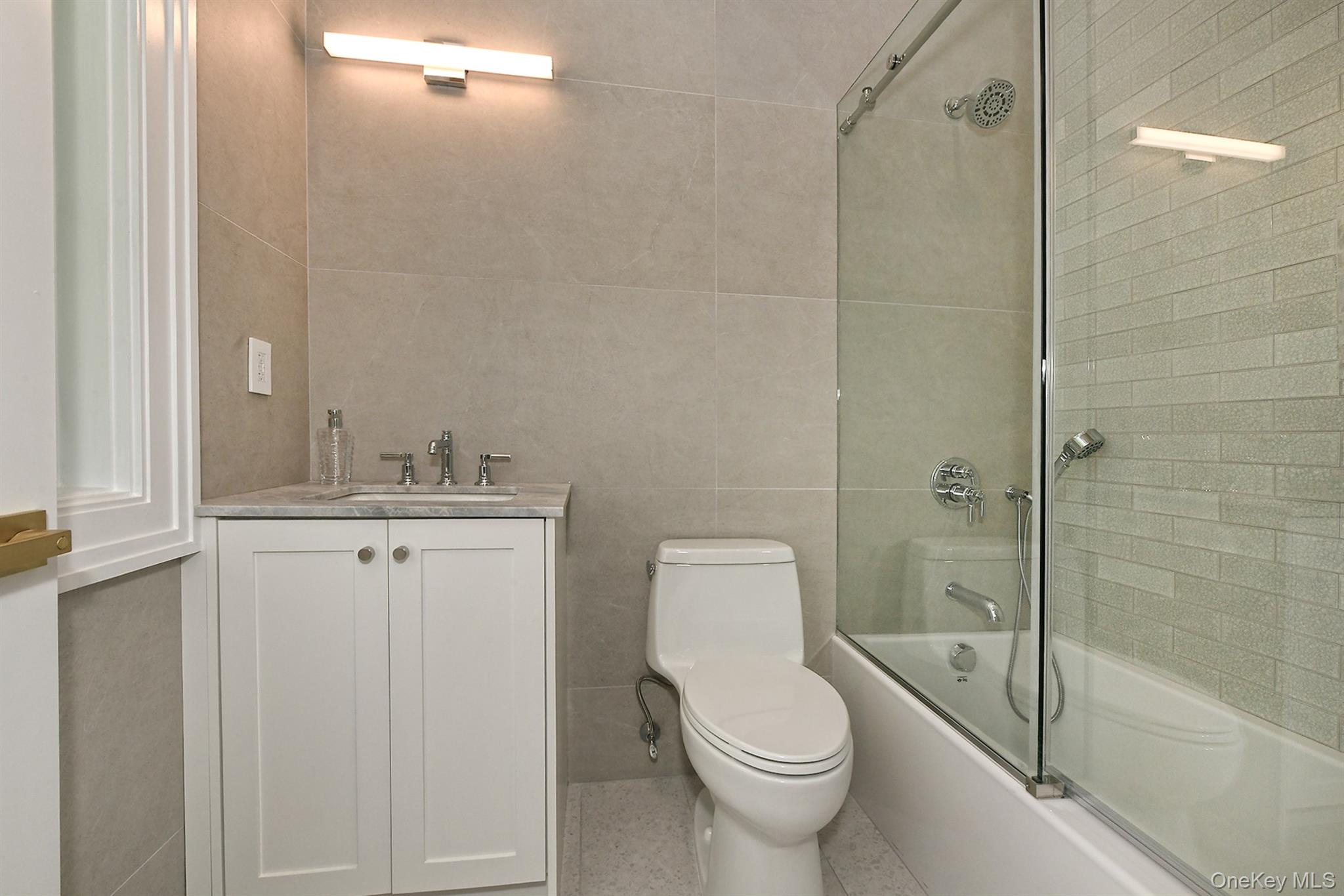 20 Knollwood Road Glen Head, NY 11545 - Photo 33 of 50 a bathroom with a granite countertop sink a toilet and shower