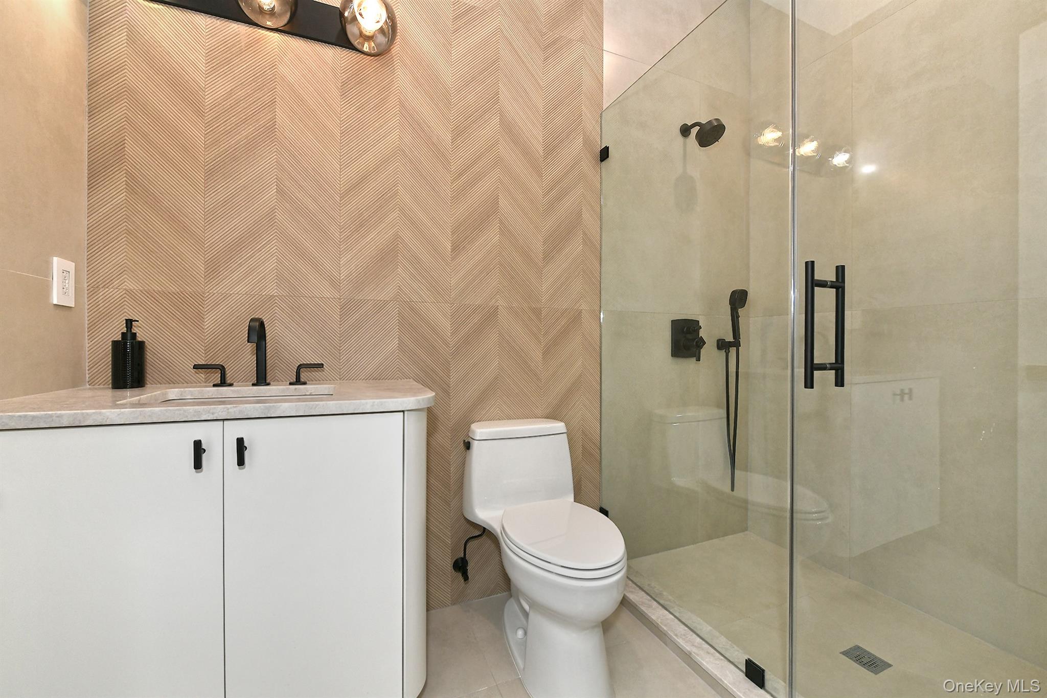 20 Knollwood Road Glen Head, NY 11545 - Photo 35 of 50 a bathroom with a toilet a sink and shower
