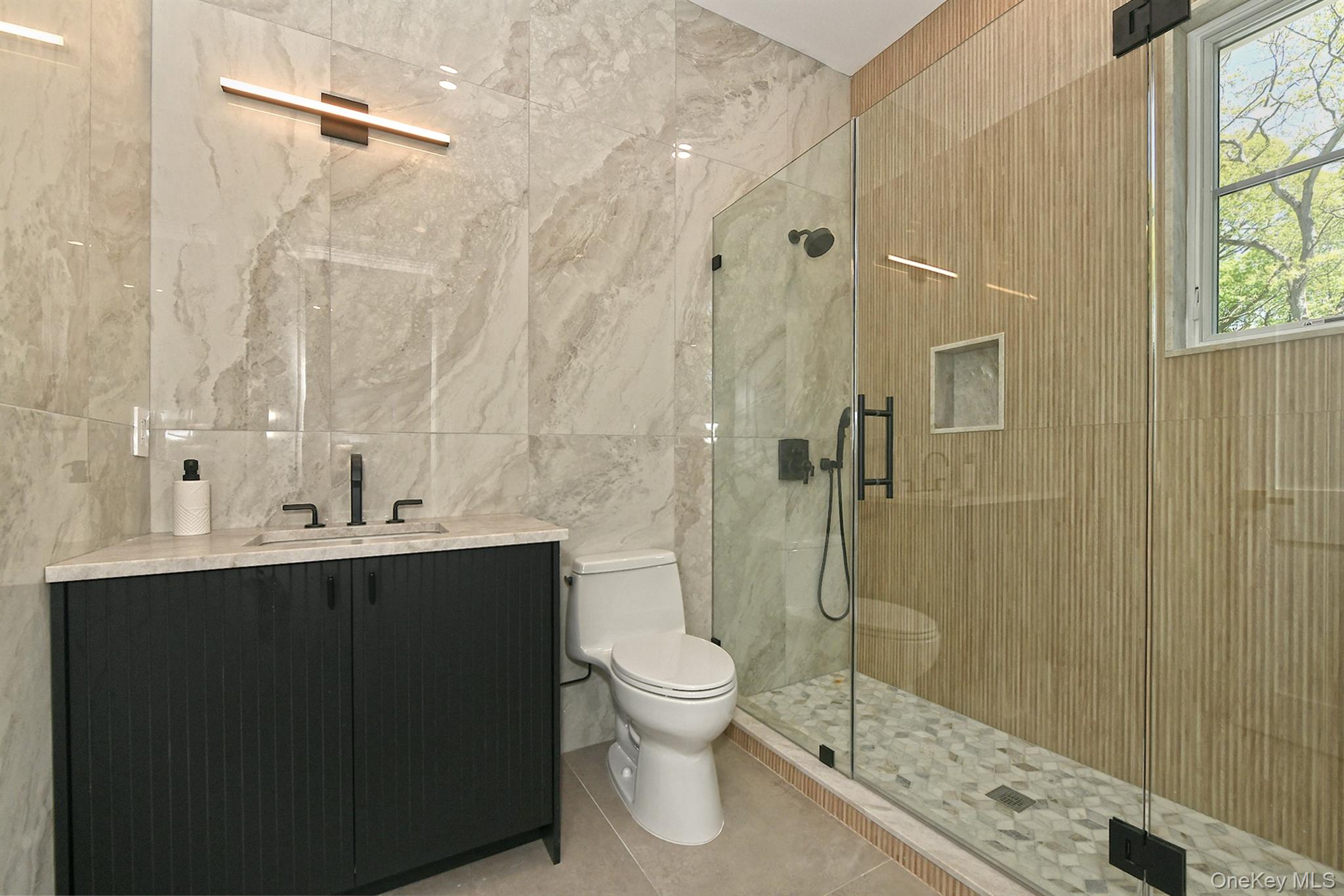 20 Knollwood Road Glen Head, NY 11545 - Photo 37 of 50 a bathroom with a sink a toilet and shower