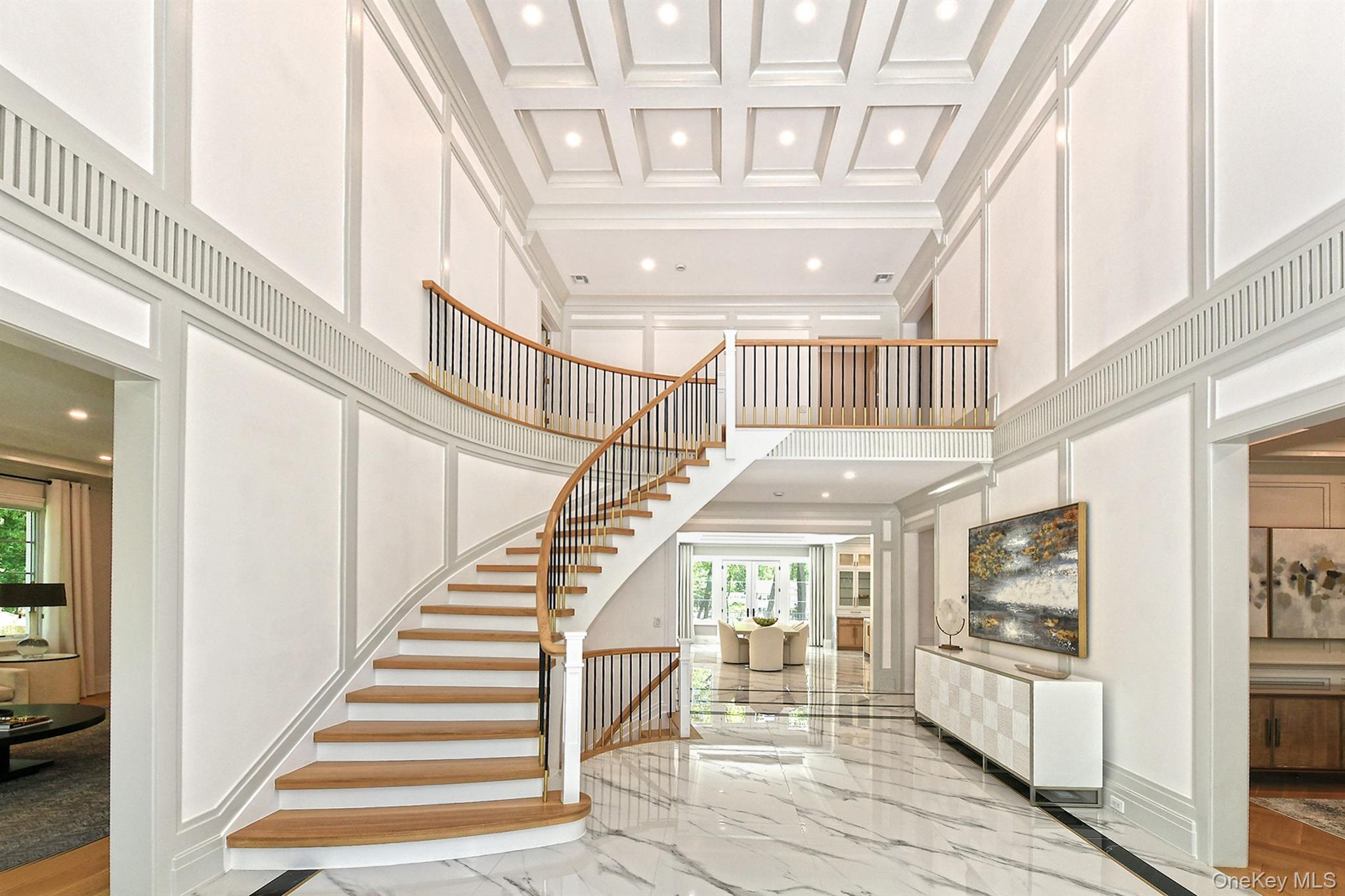 20 Knollwood Road Glen Head, NY 11545 - Photo 7 of 50 a view of staircase with lots of frames on wall and a chandelier