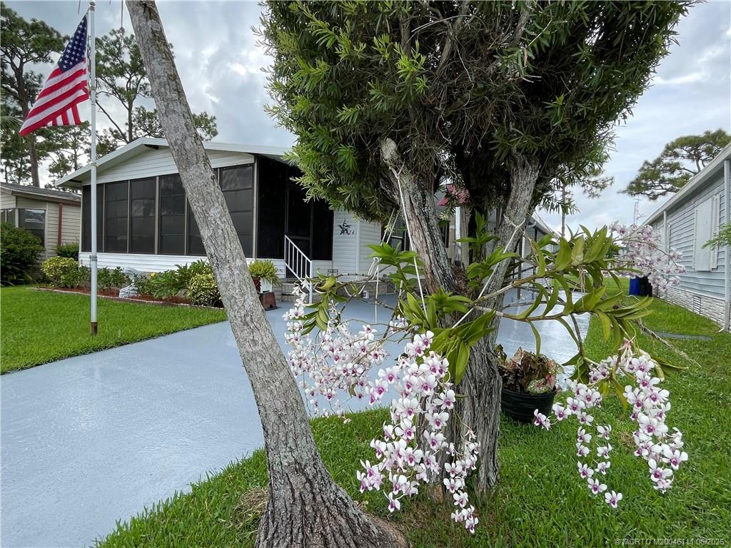 14524 Southwest Rake Drive Indiantown, FL 34956 - Photo 2 of 24 a front view of a house with a yard and a garden