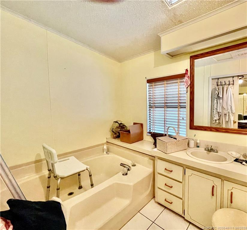 14524 Southwest Rake Drive Indiantown, FL 34956 - Photo 21 of 24 a bathroom with a tub sink and mirror