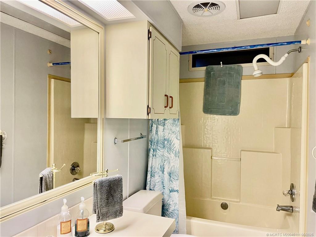 14524 Southwest Rake Drive Indiantown, FL 34956 - Photo 22 of 24 a bathroom with a bathtub and shower