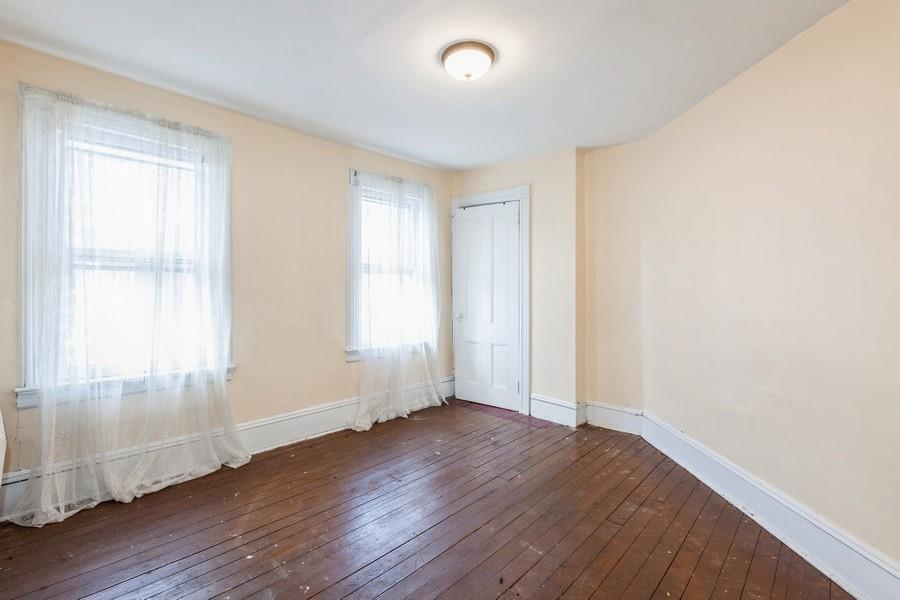 1205 Beverley Road Brooklyn, NY 11218 - Photo 17 of 34 an empty room with wooden floor and windows
