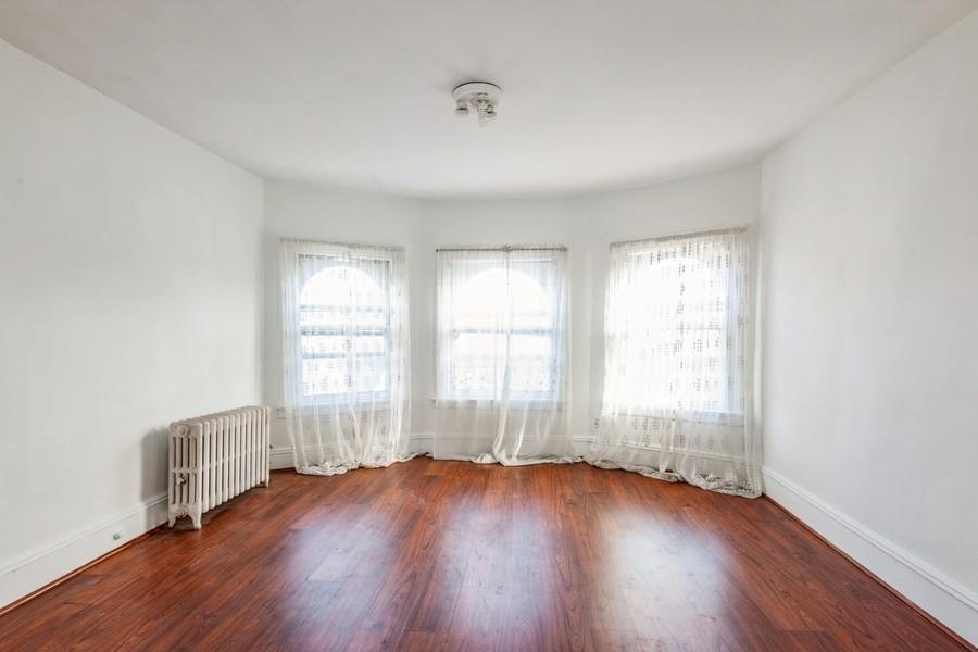 1205 Beverley Road Brooklyn, NY 11218 - Photo 19 of 34 an empty room with wooden floor and windows