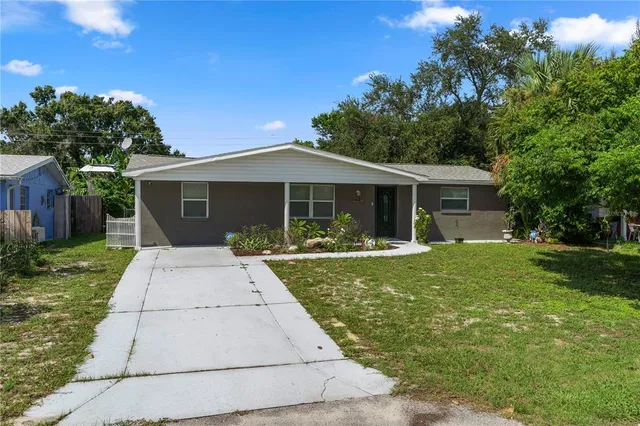 a front view of a house with yard patio and green space