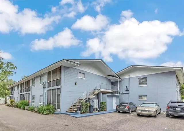a car parked in front of a white house