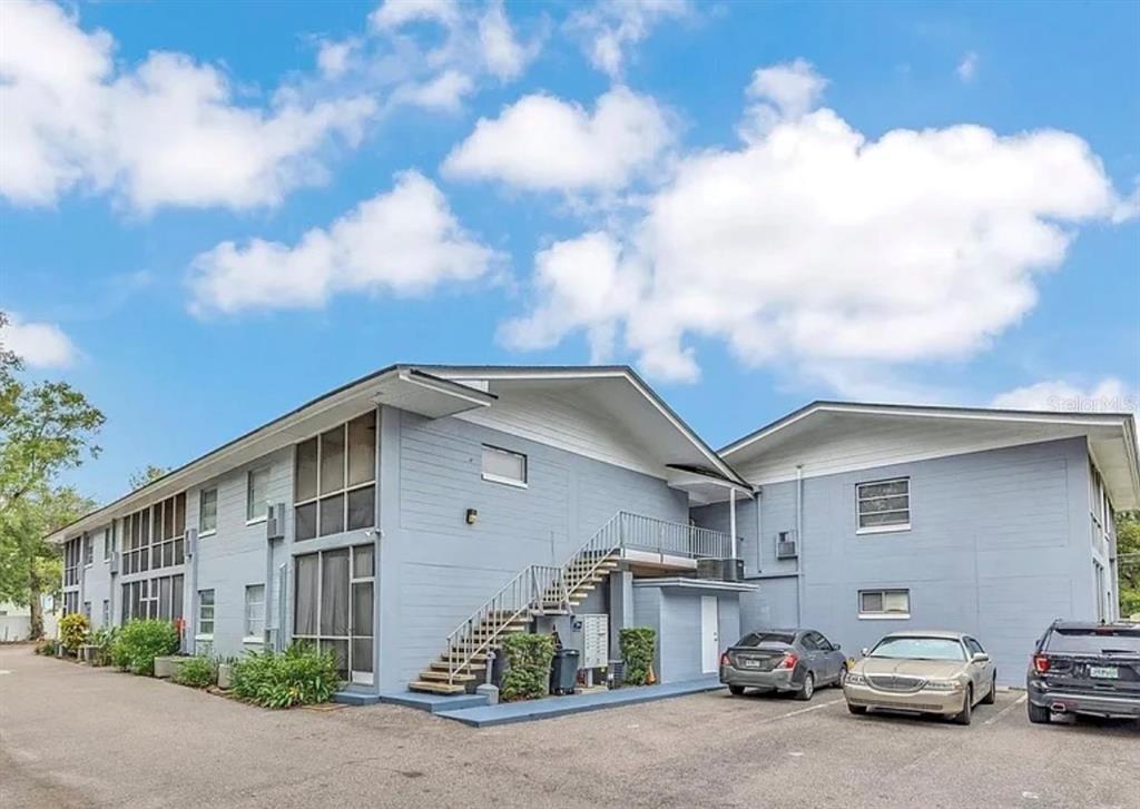 1014 East South Street, Unit 16 Orlando, FL 32801 - Photo 2 of 13 a car parked in front of a white house