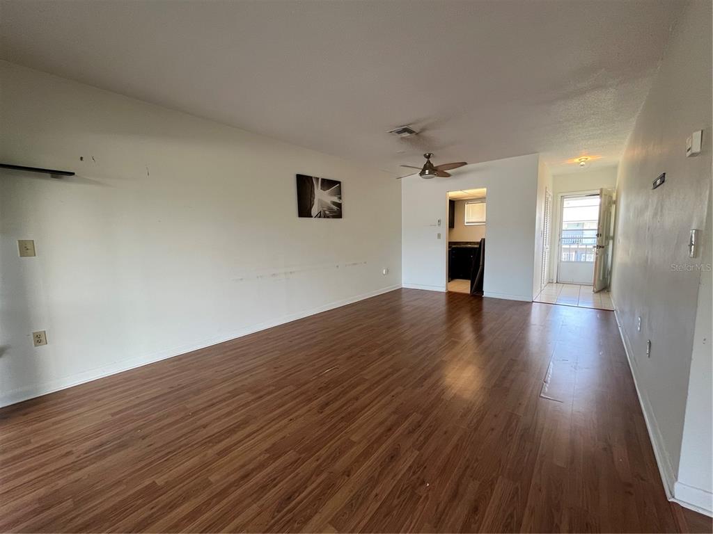 1014 East South Street, Unit 16 Orlando, FL 32801 - Photo 4 of 13 wooden floor in an empty room with a window