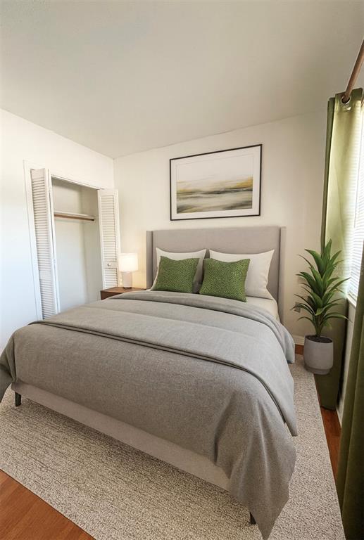 1014 East South Street, Unit 16 Orlando, FL 32801 - Photo 5 of 13 a bedroom with a large bed and a potted plant