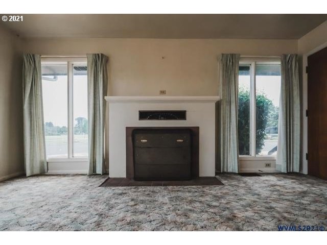 160 Tangent Street Lebanon, OR 97355 - Photo 12 of 32 a view of an empty room with a fireplace and a window