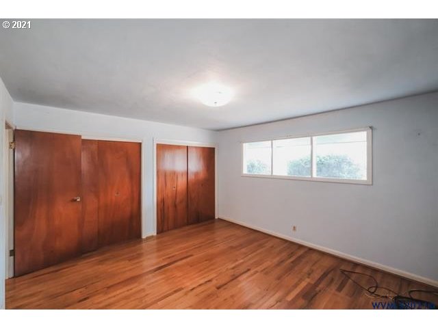 160 Tangent Street Lebanon, OR 97355 - Photo 14 of 32 an empty room with wooden floor and windows