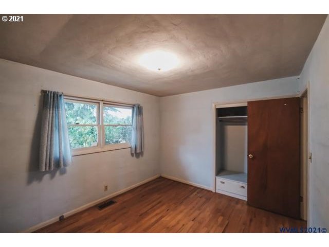 160 Tangent Street Lebanon, OR 97355 - Photo 17 of 32 a view of an empty room with wooden floor and a window