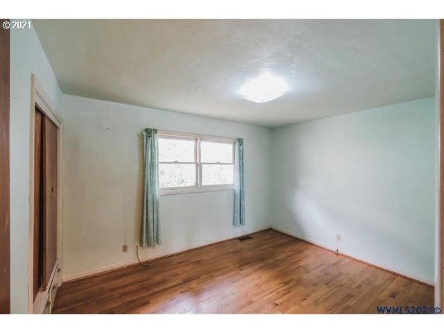 160 Tangent Street Lebanon, OR 97355 - Photo 19 of 32 a view of an empty room with wooden floor and a window