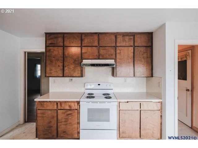 160 Tangent Street Lebanon, OR 97355 - Photo 4 of 32 a kitchen with a stove cabinets and wooden floor
