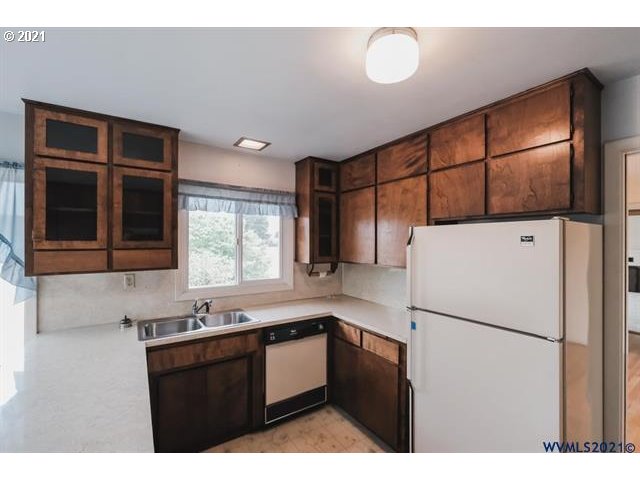 160 Tangent Street Lebanon, OR 97355 - Photo 32 of 32 a kitchen with a refrigerator and a sink