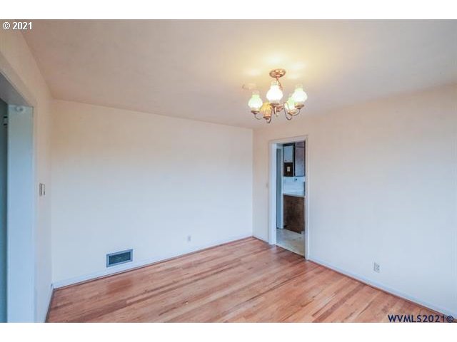 160 Tangent Street Lebanon, OR 97355 - Photo 8 of 32 a view of an empty room with a chandelier fan
