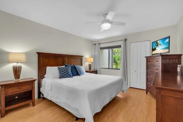 a bedroom with a bed and wooden floor