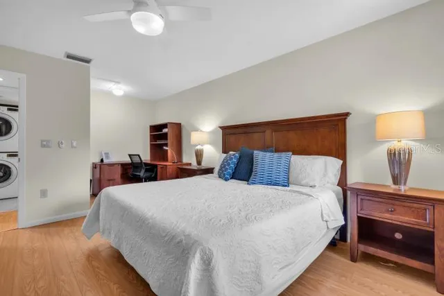 a bedroom with a bed and a night stand