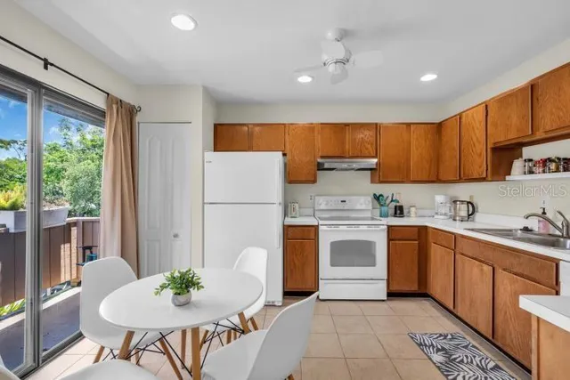 a kitchen with a sink white cabinets and stainless steel appliances