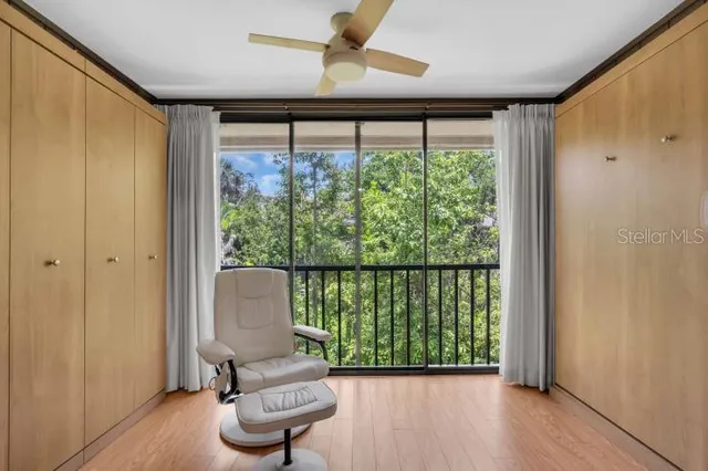 a view of a big room with wooden floor and windows