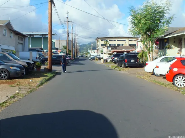 a view of street with parked cars