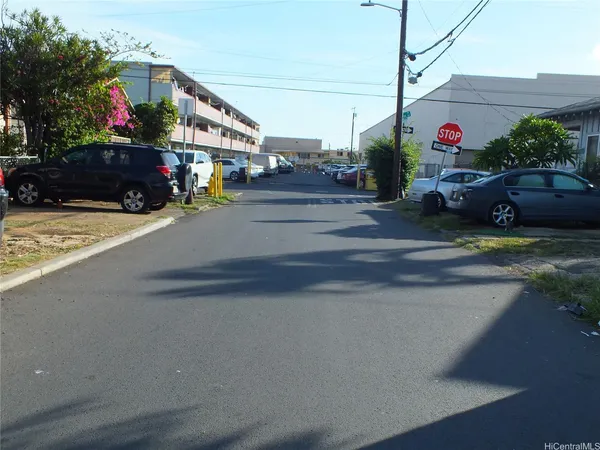 a view of street with parked cars