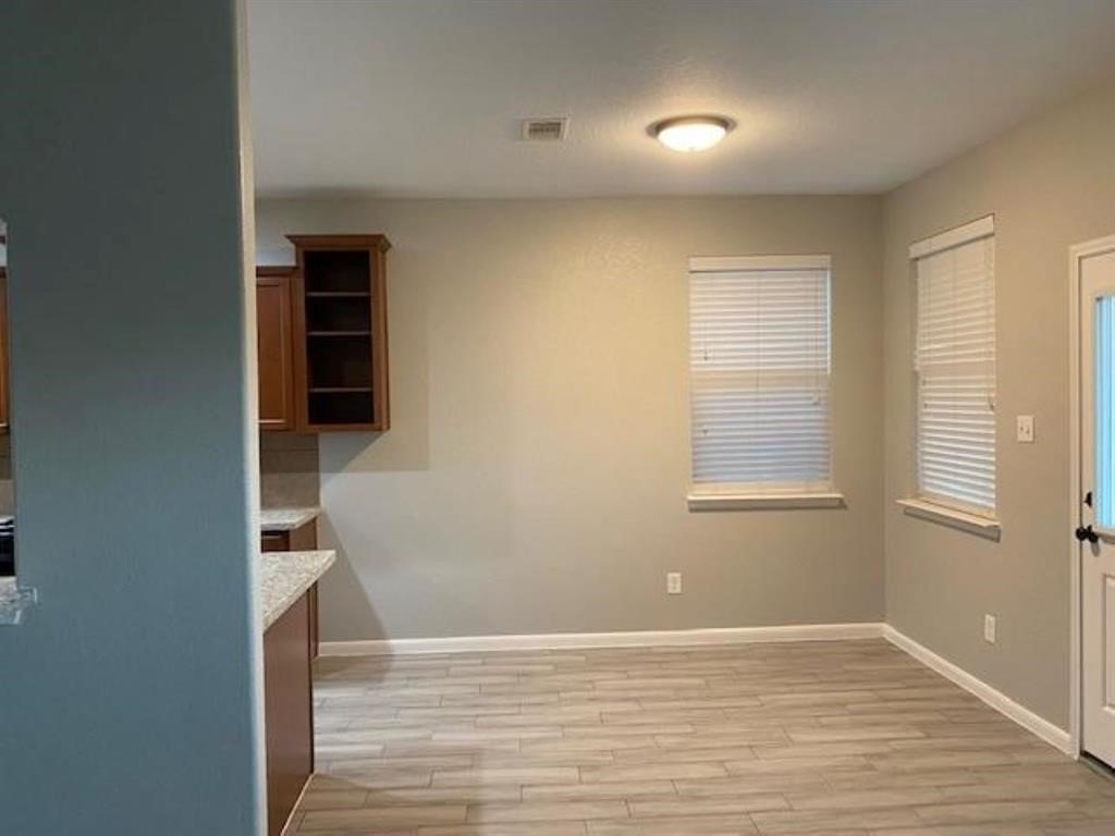 22438 Toronado Ridge Lane Porter, TX 77365 - Photo 7 of 19 Bright and inviting breakfast area with sleek flooring and ample natural light, perfect for morning gatherings.