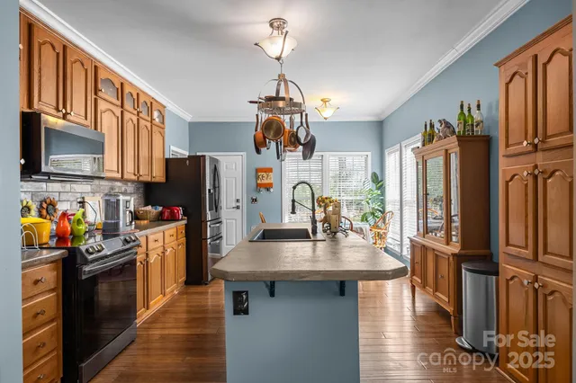 a kitchen with stainless steel appliances granite countertop a refrigerator stove microwave and sink