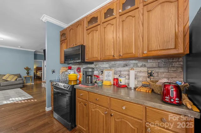 a kitchen filled with lots of clutter and stainless steel appliances