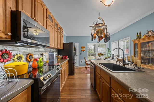 a kitchen with a sink cabinets and wooden floor