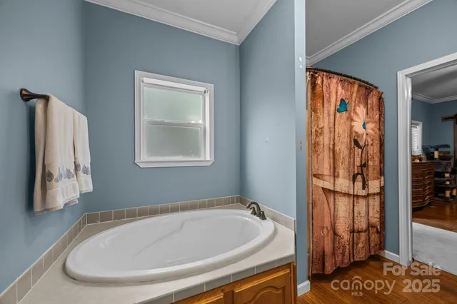 a bedroom with a bed and a flat tv screen on dresser