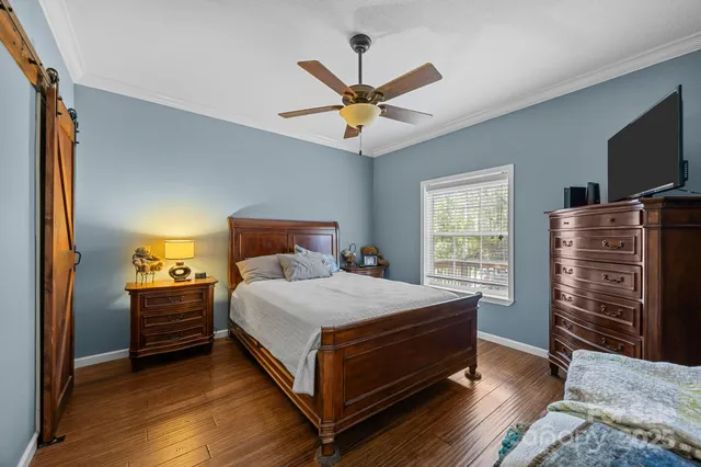 a bedroom with a bed and a chandelier
