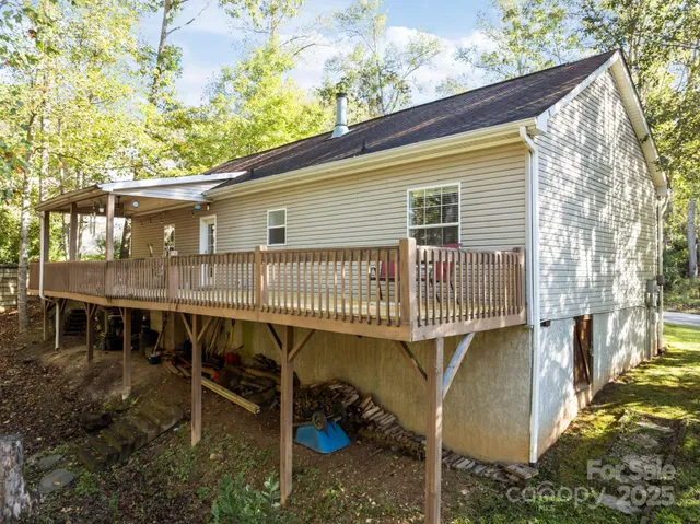 a deck view with a backyard space and balcony