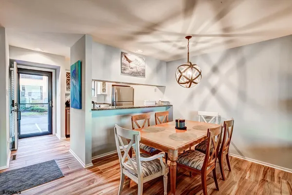 a view of a dining room with furniture wooden floor and a chandelier