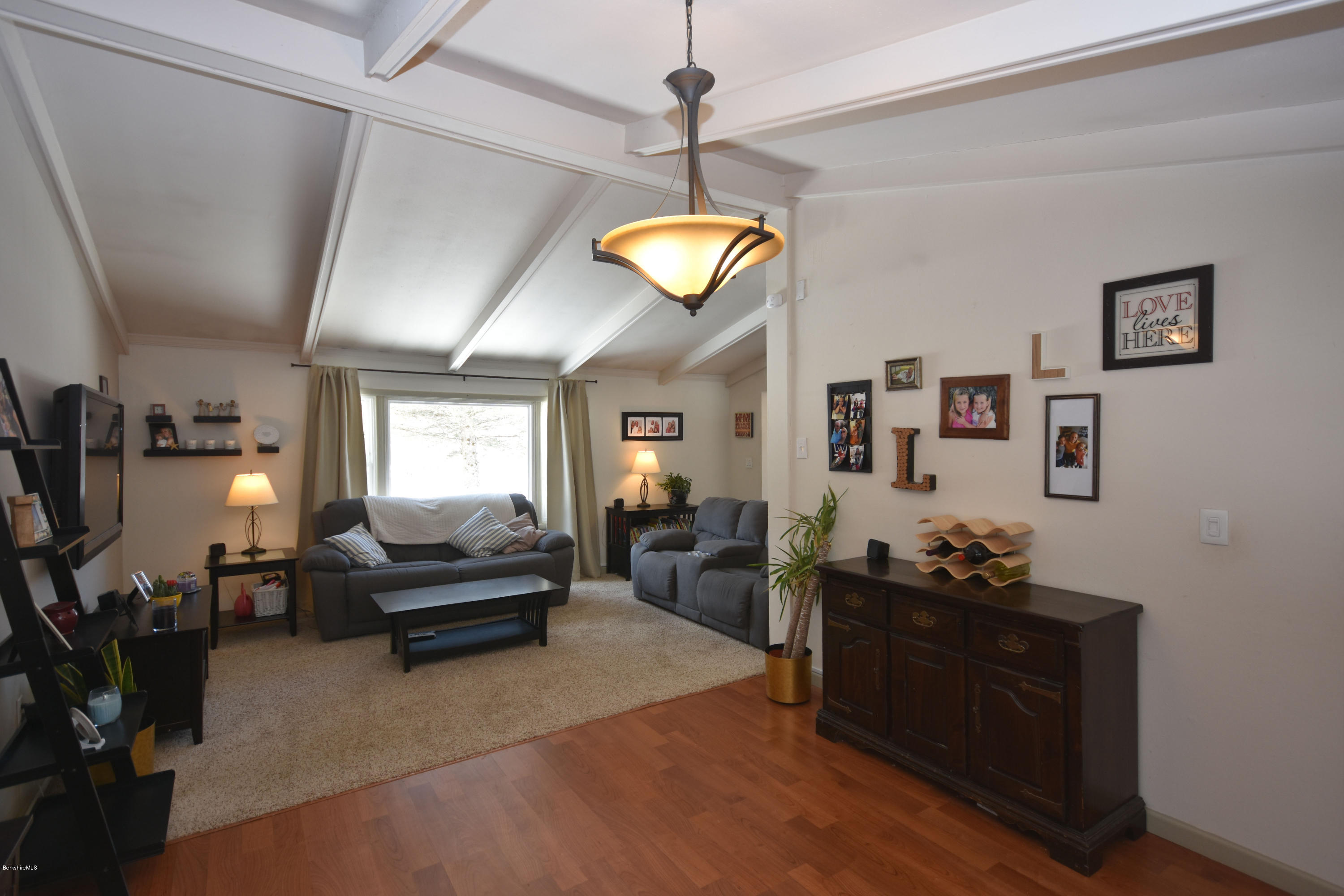 10 West Main Road Peru, MA 01235 - Photo 15 of 45 a living room with furniture chandelier and flat screen tv