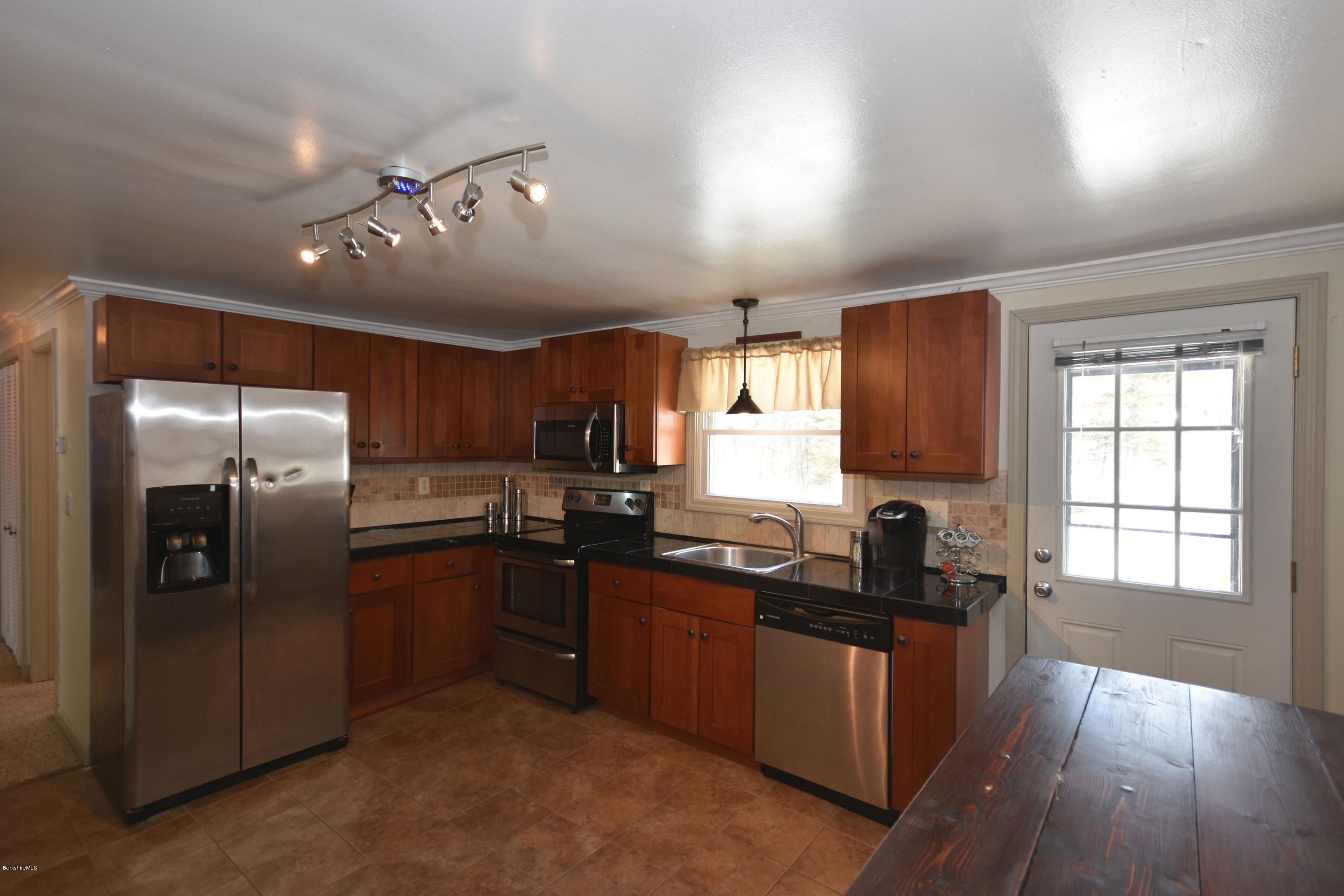 10 West Main Road Peru, MA 01235 - Photo 16 of 45 a kitchen with granite countertop stainless steel appliances cabinets a sink and a window
