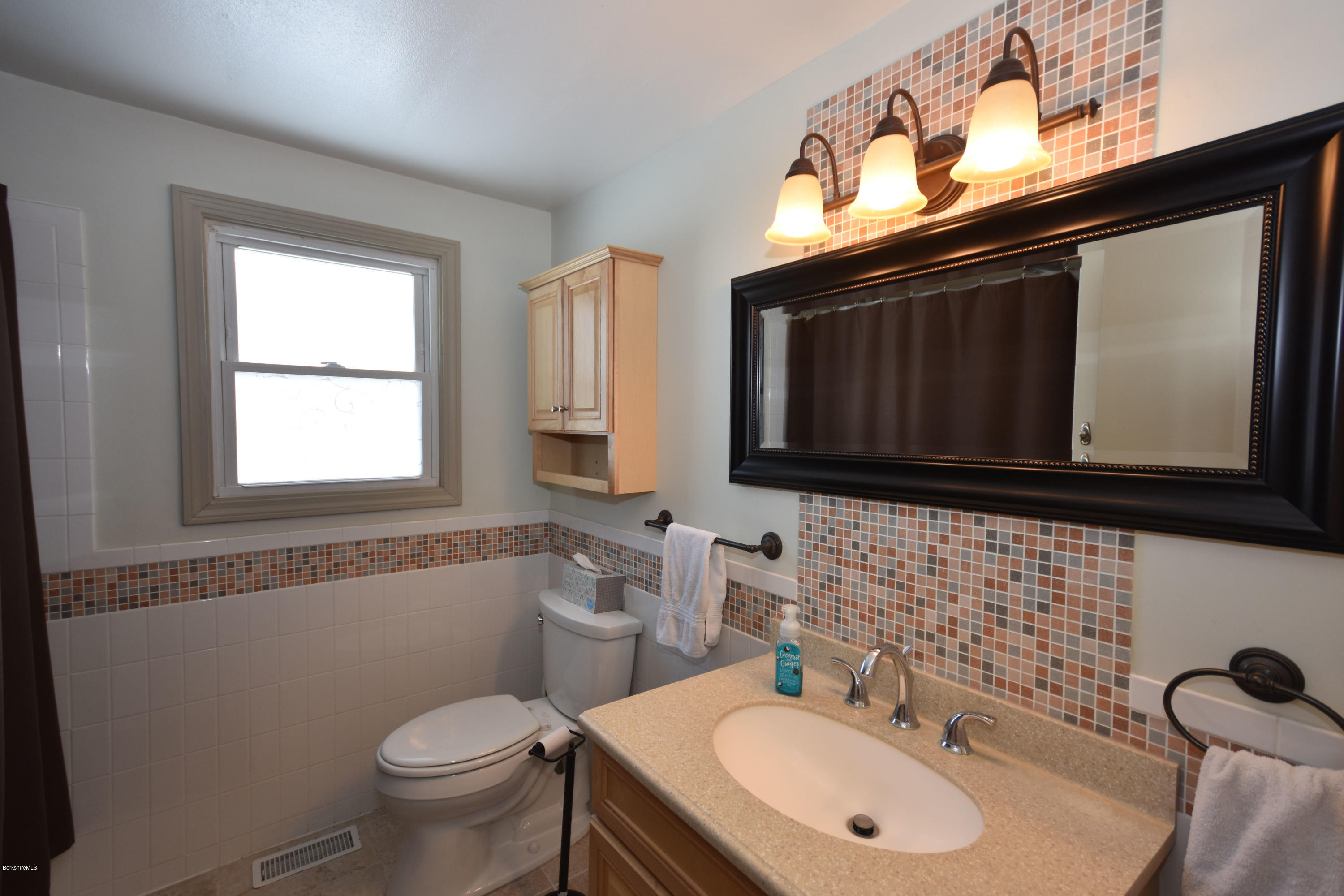 10 West Main Road Peru, MA 01235 - Photo 33 of 45 a bathroom with a toilet a sink a mirror and window