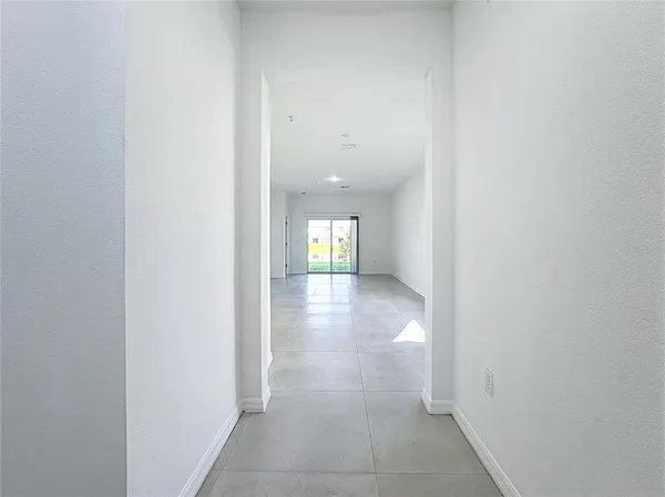 a kitchen with granite countertop a refrigerator and a sink