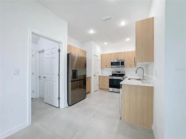 a kitchen with stainless steel appliances a refrigerator and a sink