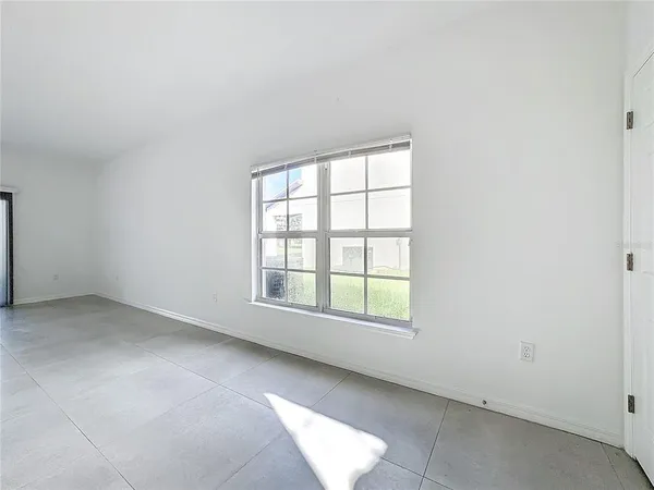 an empty room with windows and closet