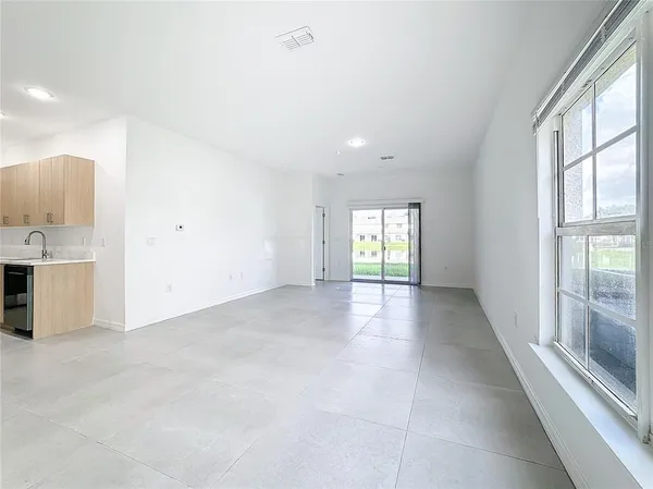 a view of a big room with windows and closet