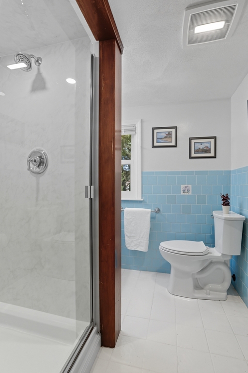 72 Collins Street Danvers, MA 01923 - Photo 15 of 24 a bathroom with a toilet a sink and shower