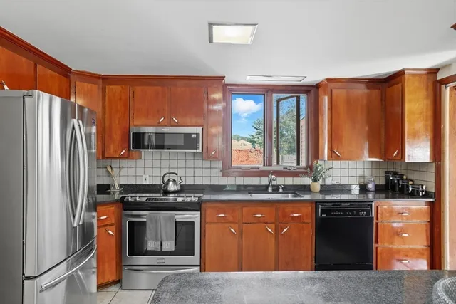 a kitchen with stainless steel appliances granite countertop a stove a sink dishwasher and a refrigerator