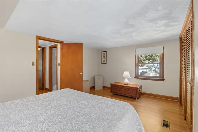 a bedroom with a bed and a window