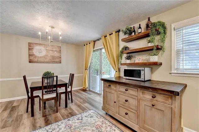 a kitchen that has a table chairs and a wooden floor