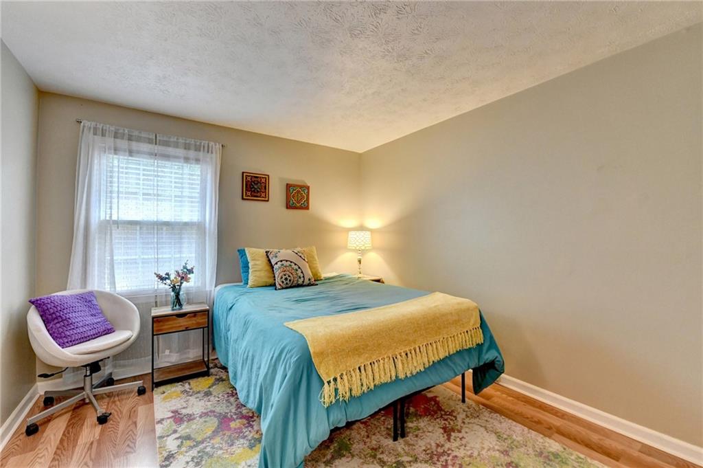 6700 Roswell Road, Unit 22B Atlanta, GA 30328 - Photo 16 of 34 a bedroom with a bed and a chandelier