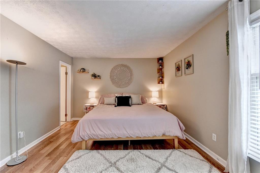 6700 Roswell Road, Unit 22B Atlanta, GA 30328 - Photo 22 of 34 a bedroom with a bed a mirror and a window