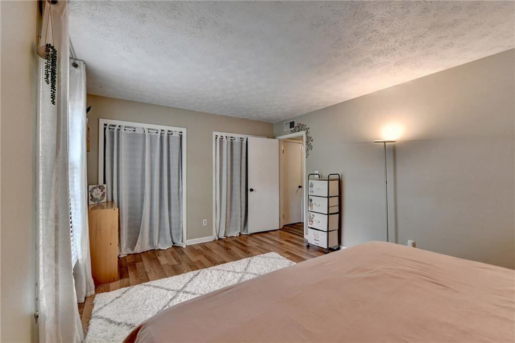 6700 Roswell Road, Unit 22B Atlanta, GA 30328 - Photo 24 of 34 a bedroom with a large bed and a closet