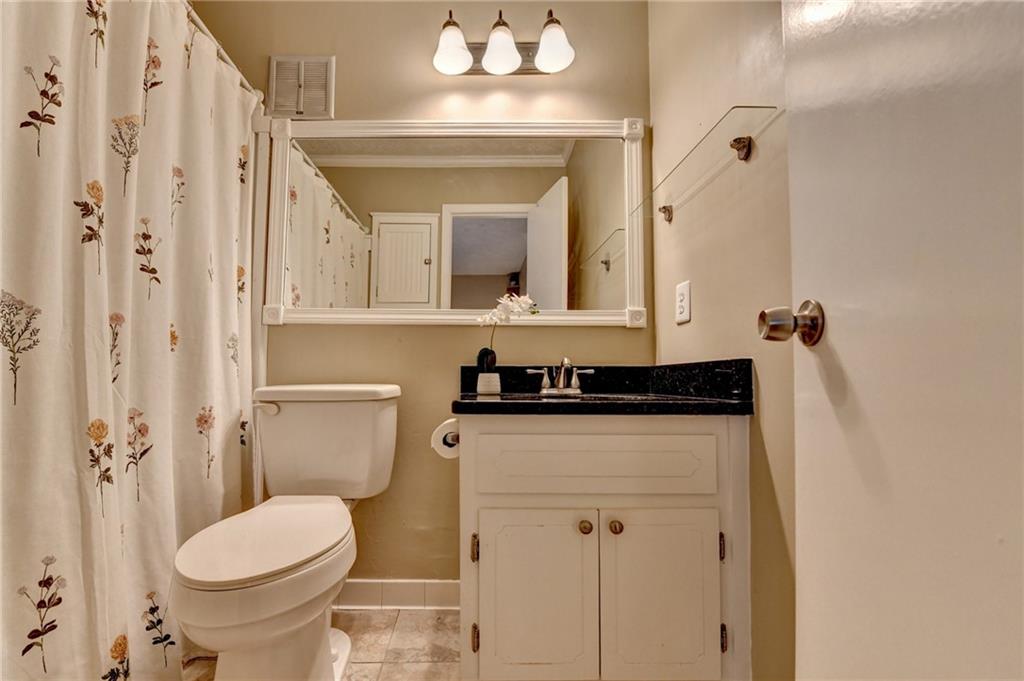 6700 Roswell Road, Unit 22B Atlanta, GA 30328 - Photo 25 of 34 a bathroom with a sink and a toilet